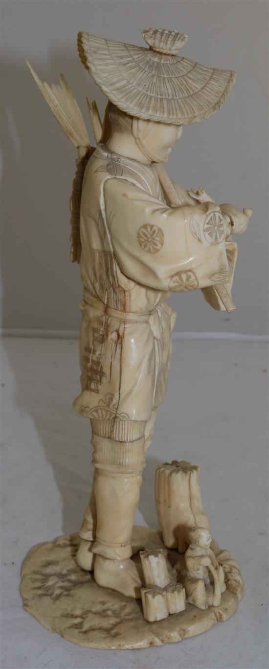 A Japanese sectional ivory figure of a flower seller, early 20th century, 26.5cm A/F